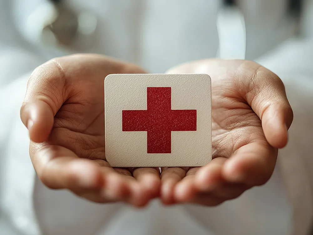 Man holding red cross for CPR Class